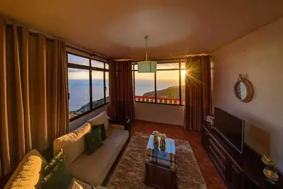 a bedroom with a large bed and a sink at Lombo Cesteiro Guesthouse in Tábua