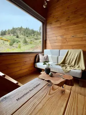 a living room with a couch and a large window at Mountain Eco Shelter 4 in Funchal