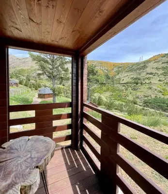 a porch with a table and a large window at Mountain Eco Shelter 4 in Funchal