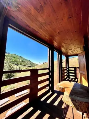 a bedroom with a bed in a room with windows at Mountain Eco Shelter 4 in Funchal