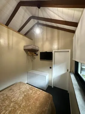 a small room with a bed and a white door at Quiet Place in Machico