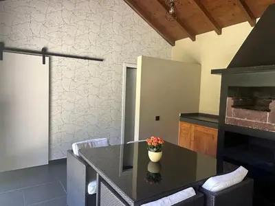 a kitchen with a table with a vase of flowers on it at Quiet Place in Machico