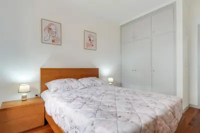 a bedroom with a large bed and a large window at Santa Cruz Apartment with Sea View by Holiday Rental Madeira in Santa Cruz