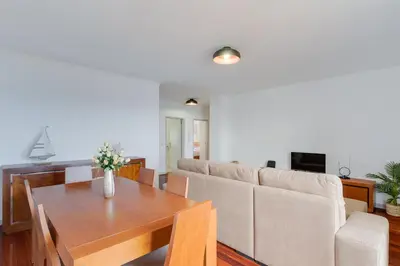 a living room with a table and a couch at Santa Cruz Apartment with Sea View by Holiday Rental Madeira in Santa Cruz