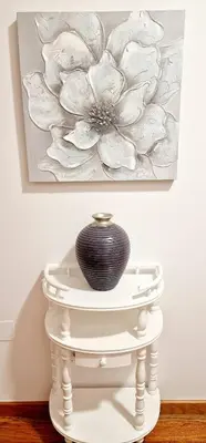 a vase on a white table in front of a painting at Ocean Pearl Apartment X in Funchal