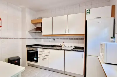 a kitchen with white cabinets and a white refrigerator at Ocean Pearl Apartment X in Funchal