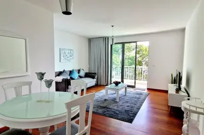 a living room with a glass table and a couch at Ocean Pearl Apartment X in Funchal