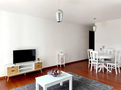a living room with a tv and a table and chairs at Ocean Pearl Apartment X in Funchal