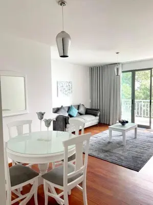 a white living room with a table and chairs at Ocean Pearl Apartment X in Funchal