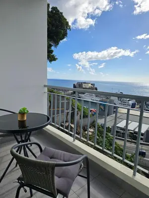 a balcony with a table and chairs and the ocean at Ocean Pearl Apartment X in Funchal