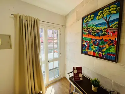 a room with a painting on the wall and a window at Charming Funchal Studio II in Funchal
