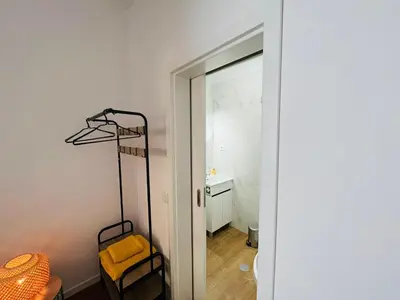 a room with a mirror and a chair next to a door at Charming Funchal Studio II in Funchal