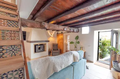 a living room with a blue couch and a fireplace at Casa Carina Espiche in Espiche