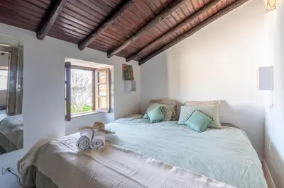 a bedroom with a bed with two towels on it at Casa Carina Espiche in Espiche