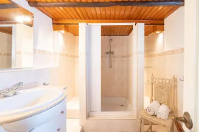 a white bathroom with a shower and a sink at Casa Carina Espiche in Espiche