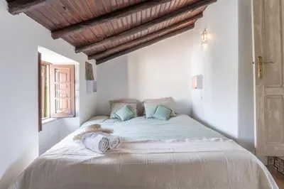 a bedroom with a large bed with towels on it at Casa Carina Espiche in Espiche