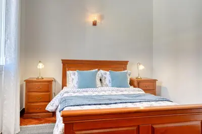 a bedroom with a large bed with two night stands at Casa do Valentim, a Home in Madeira in Ponta do Sol
