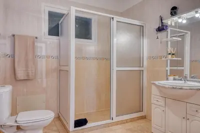 a bathroom with a shower and a toilet and a sink at Casa do Valentim, a Home in Madeira in Ponta do Sol
