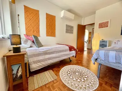 a living room with a couch and a bed at Avenue Q, Beach Apartment in Luz in Luz