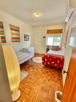 a room with a bedroom with a bed and a couch at Avenue Q, Beach Apartment in Luz in Luz