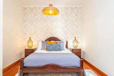 a bedroom with a bed and two night stands at Gaula Residence by Homie in Santa Cruz