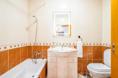 a bathroom with a tub and a sink and a toilet at Gaula Residence by Homie in Santa Cruz