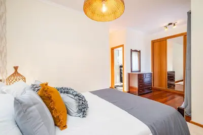 a bedroom with a white bed with pillows at Gaula Residence by Homie in Santa Cruz