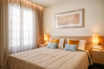 a bedroom with a large bed with two pillows at Colombo Square, a Home in Madeira in Funchal