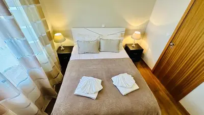 a bedroom with a bed with two pillows on it at CASA CAROTO in Porto Moniz