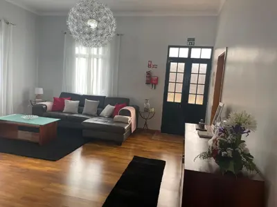 a living room with a couch and a table at CASA CAROTO in Porto Moniz