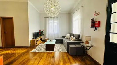 a living room with a couch and a table at CASA CAROTO in Porto Moniz