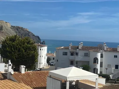 a white building with a white tent in front of it at Casa Sea Love Luz in Luz