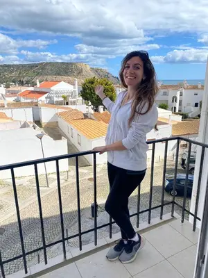 a woman standing on top of a balcony at Casa Sea Love Luz in Luz