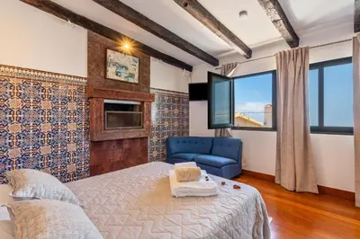 a bedroom with a bed and a blue chair at Panoramic Views I I in Caniço