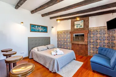 a bedroom with a bed and a blue couch at Panoramic Views I I in Caniço