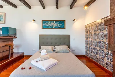 a bedroom with a bed and a tv in it at Panoramic Views I I in Caniço
