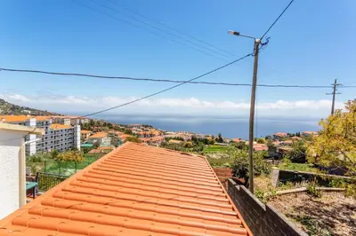 a view of the ocean from the roof of a house at Panoramic Views I I in Caniço