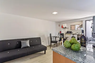 a kitchen with a sink and a couch in a room at Panoramic Views I I in Caniço