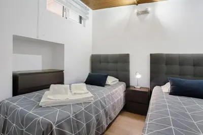 two beds sitting next to each other in a room at Panoramic Views I in Caniço