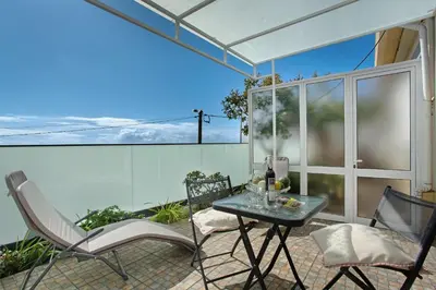 a patio with a table and chairs on a balcony at Panoramic Views I in Caniço
