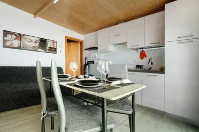 a kitchen with a table and chairs in a room at Panoramic Views I in Caniço