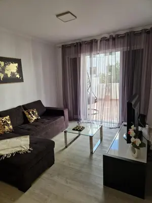 a living room with a couch and a coffee table at Lovely Apartment Funchal in Funchal