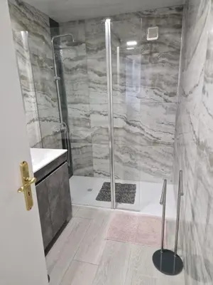 a bathroom with a shower with a glass door at Lovely Apartment Funchal in Funchal