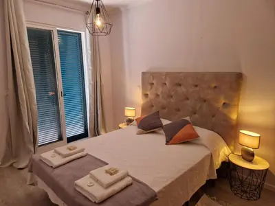 a bedroom with a large bed with two towels on it at Lovely Apartment Funchal in Funchal