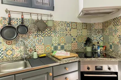 a kitchen with tiles on the wall and a sink at Palmeira House - Fernandes Cottage in Ponta Delgada