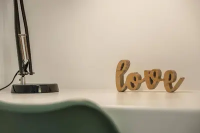 a desk with a desk top with the word love on it at Palmeira House - Fernandes Cottage in Ponta Delgada