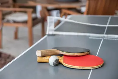 a table with two wooden utensils on top of it at Palmeira House - Fernandes Cottage in Ponta Delgada