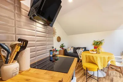 a living room with a table and a couch at Cork House - Fernandes Cottage in Ponta Delgada