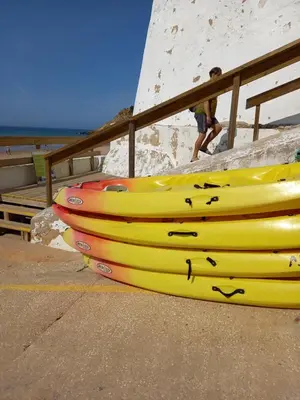 a group of yellow boats sitting on the beach at Casa Luna, Burgau - Luz, Lagos in Burgau