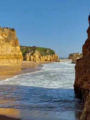 a beach with some rocks and the ocean at Casa Luna, Burgau - Luz, Lagos in Burgau